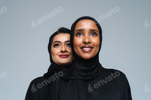 Preview: Beautiful arab middle-eastern women with traditional abaya in studio