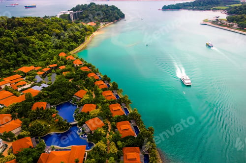 Preview: Aerial view of boats on turquoise water and reddish building roofs on Sentosa Island. Singapore.