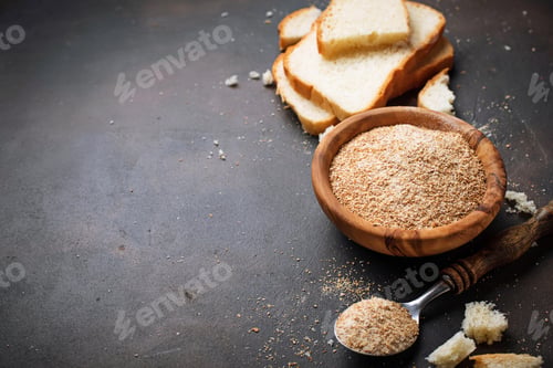 Preview: Bowl of breadcrumbs and slices of a loaf