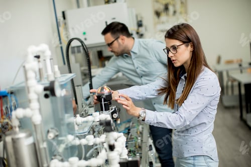 Preview: Young couple of students working at robotics lab