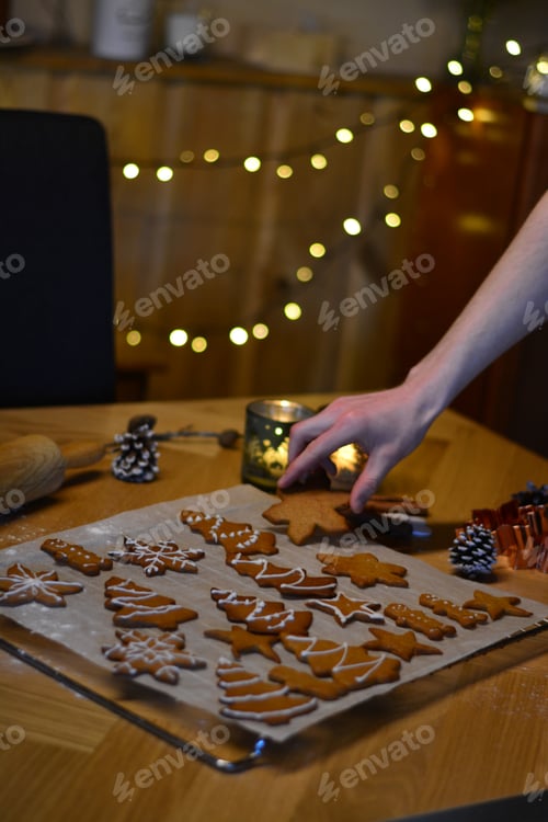 Preview: Person Preparing Decorated Festive Christmas Cookies At Home