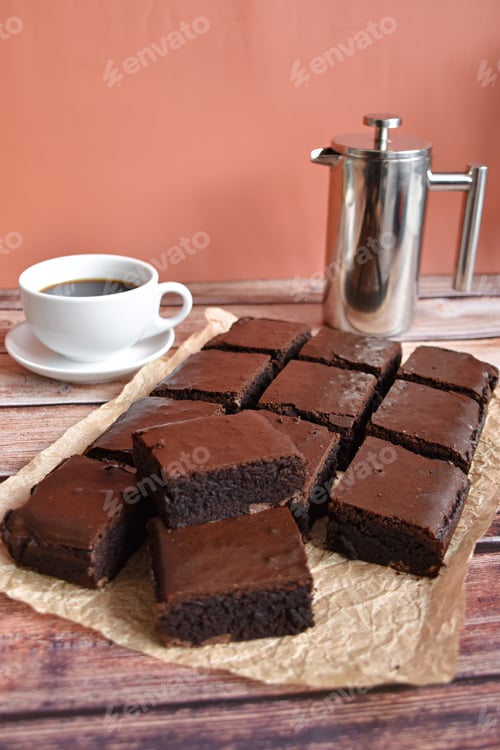 Preview: cup of coffee, coffee maker and a pile of brownies on brown paper
