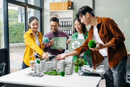 Preview: Group of diverse multiethnic businesspeople standing neare table looking at model