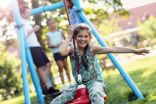 Preview: Joyful family having fun on playground