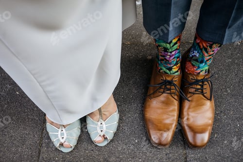 Preview: People standing side-by-side, wearing matching shoes and socks, against a plain background