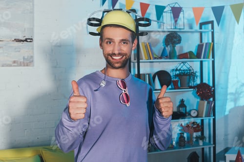 Preview: young man in beer hat showing thumbs up and smiling at camera