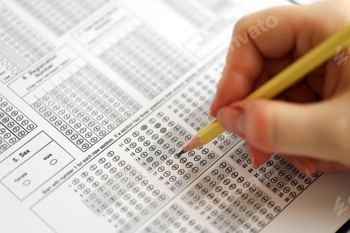 Preview: Female student hands testing in exercise and taking fill in exam paper sheet