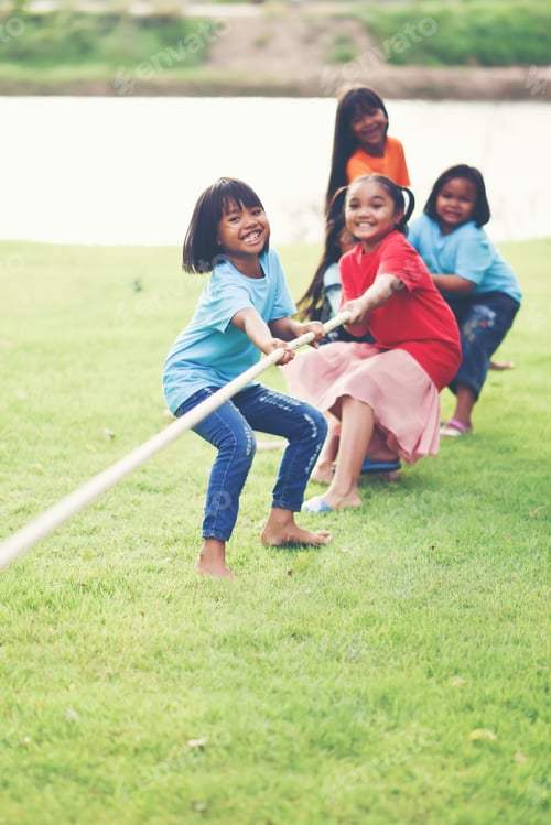 Preview: Children group playing tug of war at the park