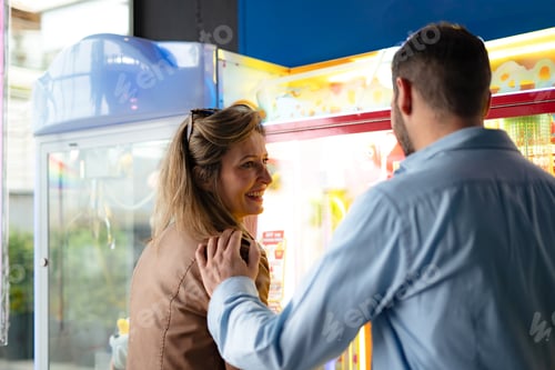 Preview: young woman playing a strength tester game at an amusement arcade