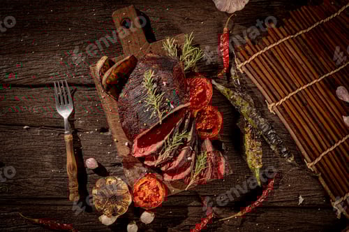 Preview: Sizzling Steak Feast: Juicy sliced steak on a rustic wooden table, adorned with grilled vegetables a