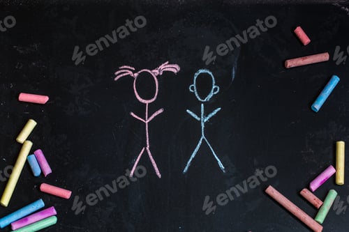 Preview: colored chalks, black blackboard with the drawings of little girl and boy