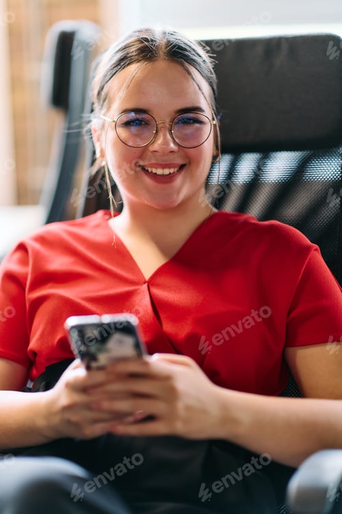 Preview: A businesswoman resting on a short break from work in a modern startup coworking center, using her