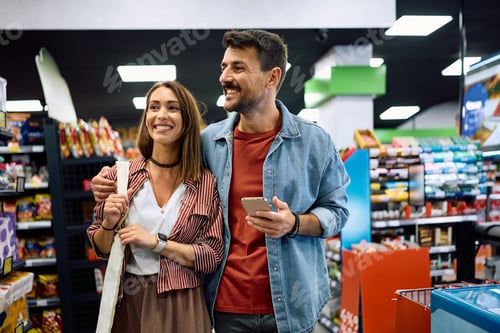 Preview: Happy couple shopping together in supermarket.