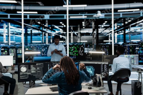 Preview: Fatigued data center admin stretching at desk, using machine learning algorithms