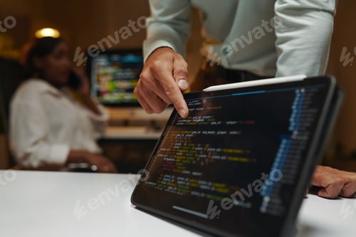 Preview: Developer Pointing at Programming Code