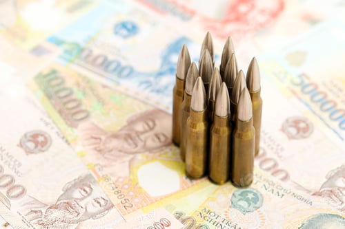 Preview: Vietnamese dong currency money bills and rifle bullets. The concept of warfare and gun selling