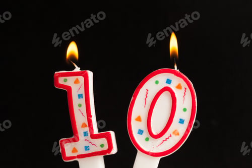 Preview: Celebration with candles showing the number ten lit up against a dark background
