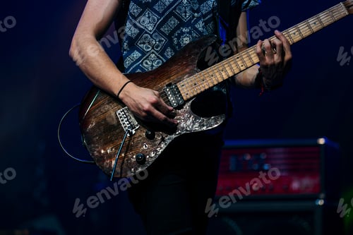 Preview: Guitarist performing at a live concert.