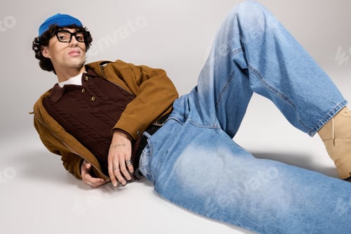 Preview: Stylish young man poses confidently in trendy outfit for a modern fashion lookbook