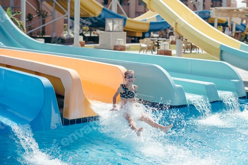 Preview: girl rides a water slide in a water park