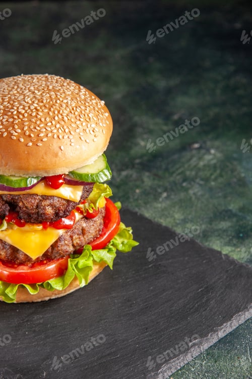 Preview: Close up shot of delicious meat sandwich with tomatoes green on dark color tray on black background