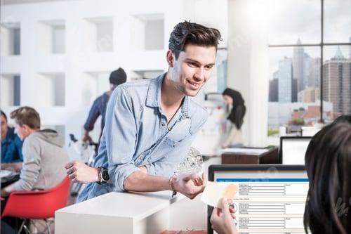 Preview: Young man in office smiling at female colleague