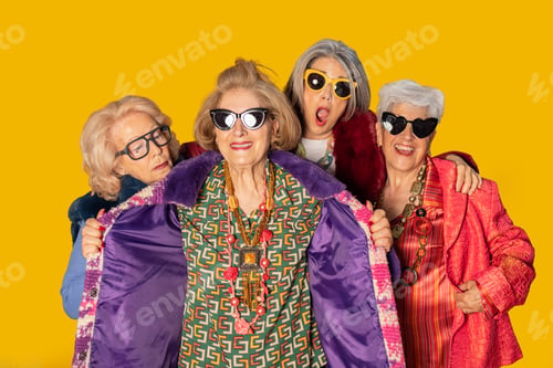 Preview: Group of stylish senior women showing fashion and attitude on yellow background