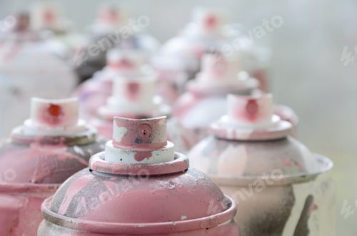 Preview: A lot of dirty and used aerosol cans of bright pink paint