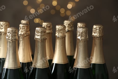 Preview: Many bottles of champagne on blurred background, closeup