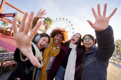 Preview: Four cheerful young friends taking selfie portrait in winter clothes. Happy people looking camera