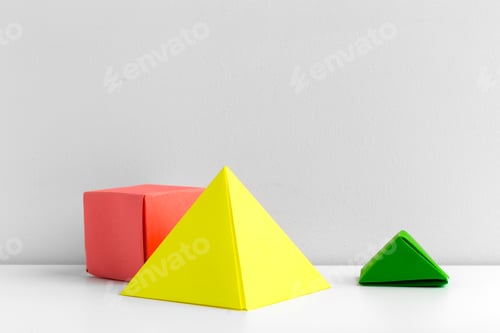 Preview: Colorful geometric shapes arranged on a white surface in a modern setting