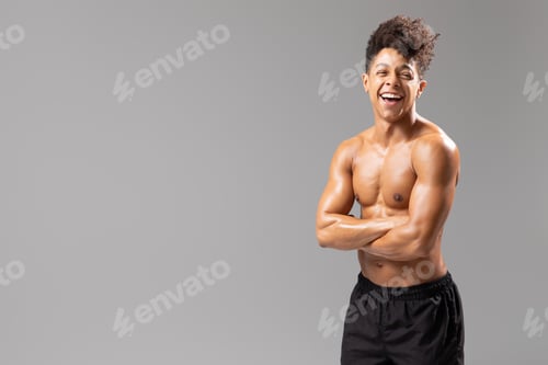 Preview: Young Brazilian man showcasing fitness and healthy lifestyle in studio