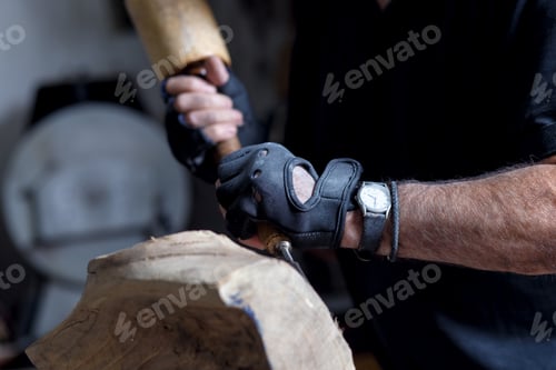 Preview: Close up of senior sculptor hands working on his sculpture in his workshop.