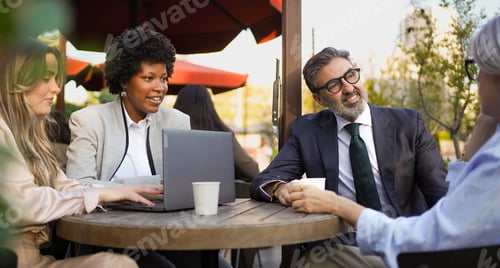 Preview: Business people having a meeting at outdoor cafe
