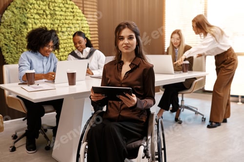 Preview: Confident disabled woman using tablet in inclusive modern office