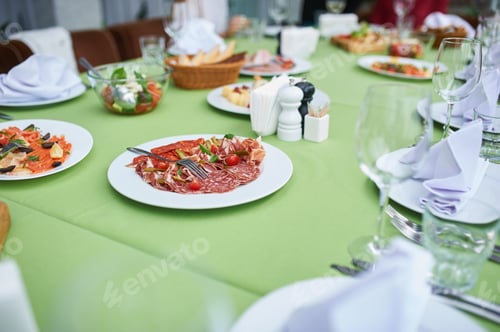 Preview: banquet treats on the table during the party. Sausage plate in the center of the table