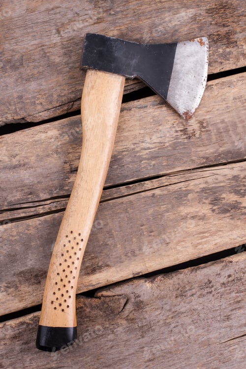 Preview: Rusty axe on old wooden boards