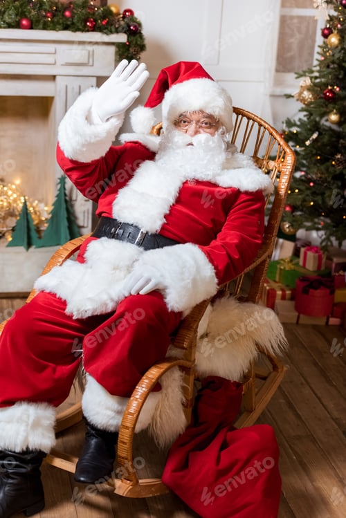 Preview: santa claus waving at camera while sitting in rolling chair