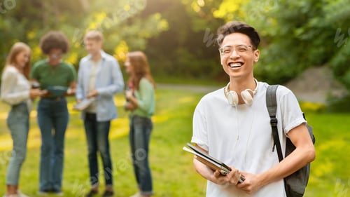 Preview: Portrait Of Happy Asian Student Guy With Workbooks And Backpack Posing Outdoors