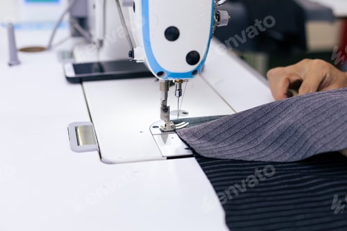 Preview: Tailor working on electric sewing machine