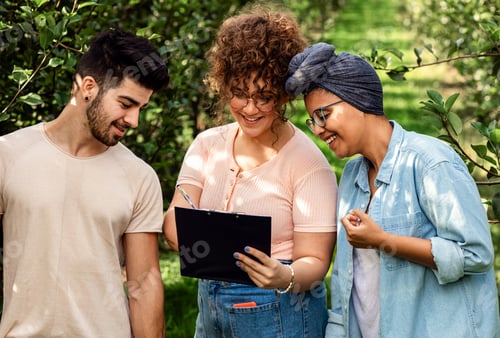 Preview: Group of agriculture students examines the fruit yield in a pear orchard.