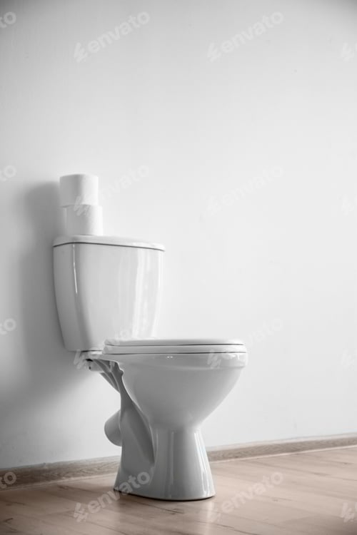 Preview: New ceramic toilet bowl near light wall