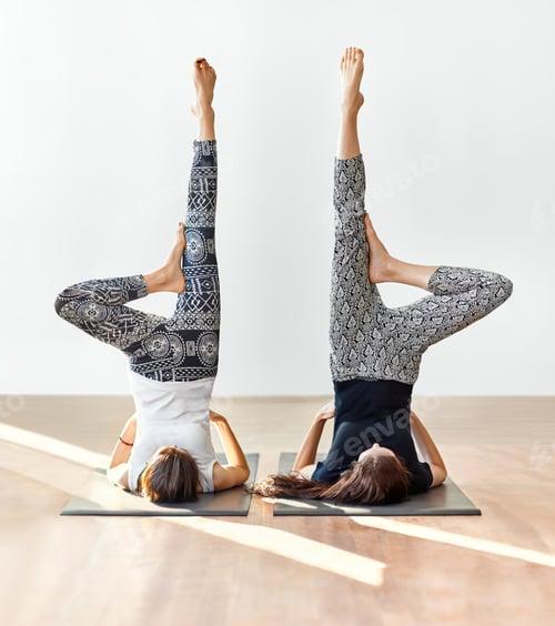 Preview: Two young women doing yoga asana supported shoulderstand
