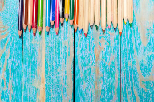 Preview: Colored pencils arranged on a wooden table ready for drawing and coloring activities