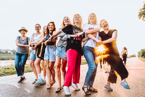 Preview: dancing cheerful attractive women at sunset.