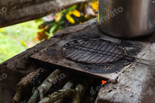 Preview: Grill for making traditional Colombian arepas on top of a handmade stove made of bricks and ashes