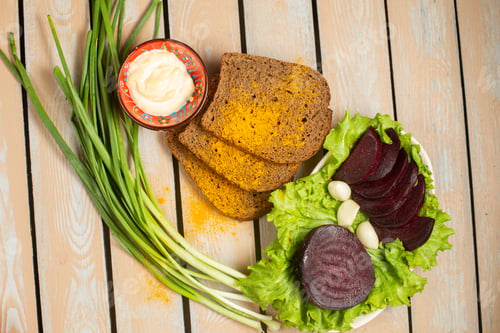 Preview: top view bread loafs with green onion and beet on the wooden desk bread greens vegetable