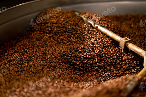 Preview: close-up of a coffee roasting factory inside drum roasting stirring coffee