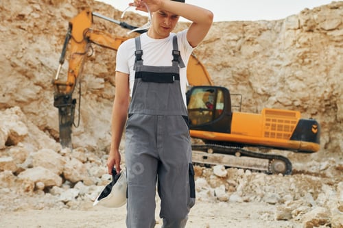 Preview: Operator is working on the borrow pit. Man in professional uniform
