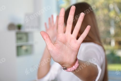 Preview: Woman showing stop gesture in office. Problem of sexual harassment at work
